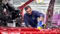 worker assembles an electric vehicle